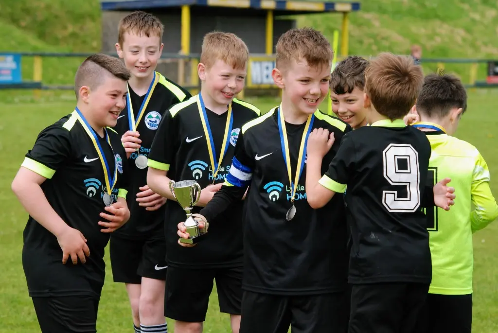 Squad celebrating with trophies