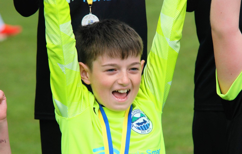 Young goalkeeper celebrating with Glens United