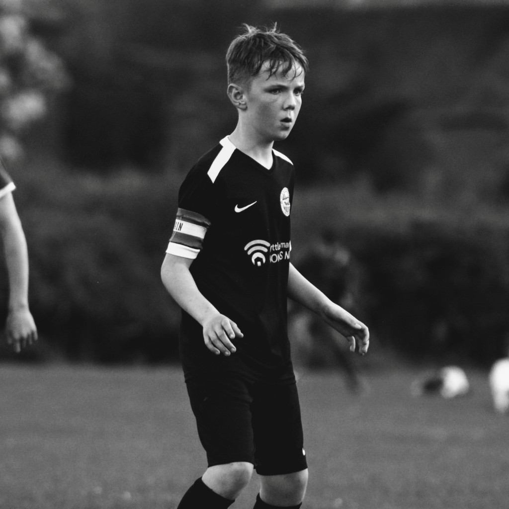 Monochrome photo of a Glens United captain